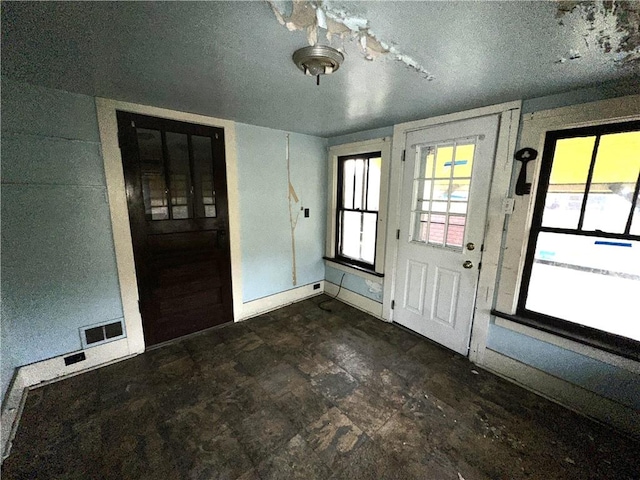 entrance foyer with baseboards and visible vents