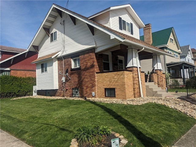 view of side of home featuring a yard and brick siding