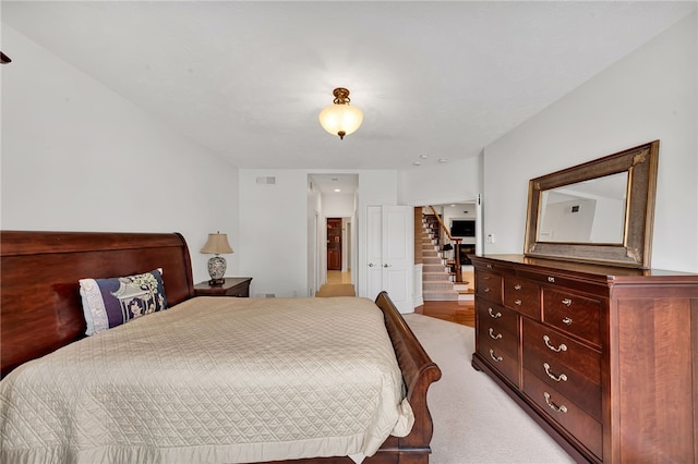 bedroom featuring light carpet and visible vents