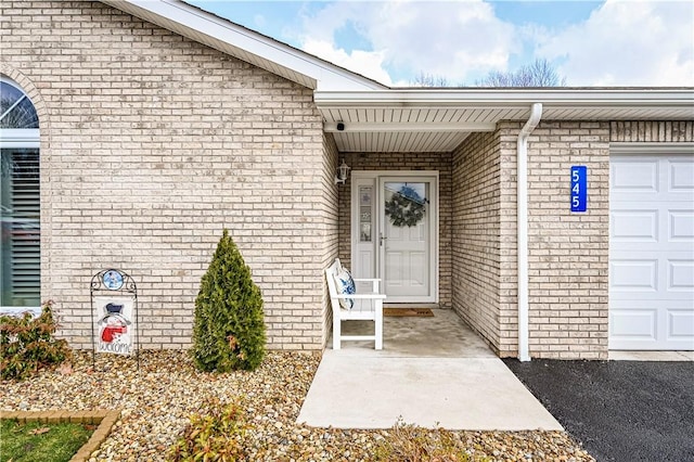 view of exterior entry with an attached garage