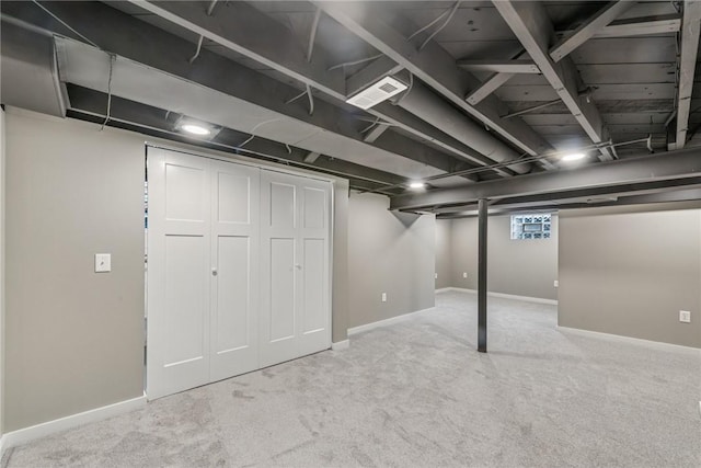 finished basement featuring carpet floors, baseboards, and visible vents