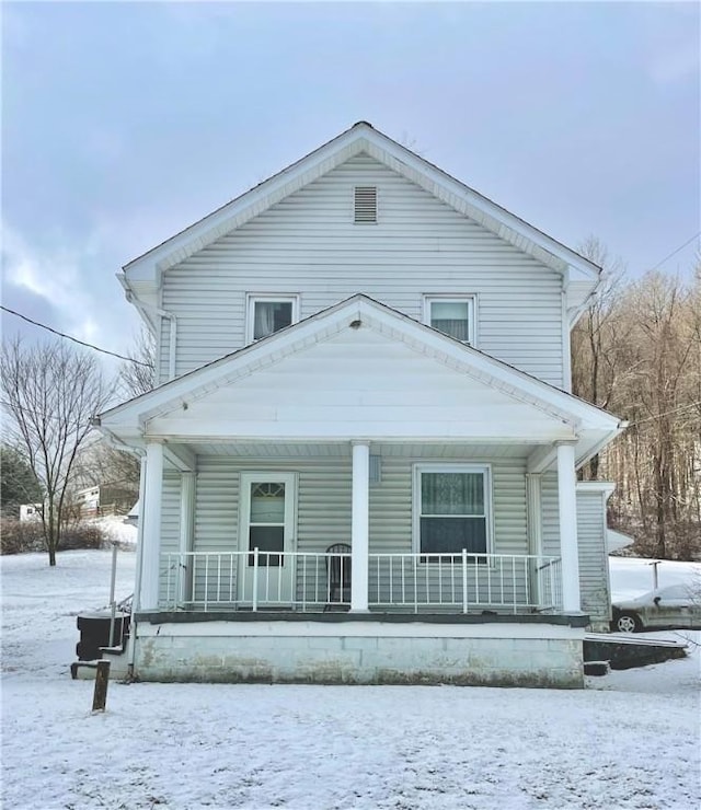 snow covered house with a porch