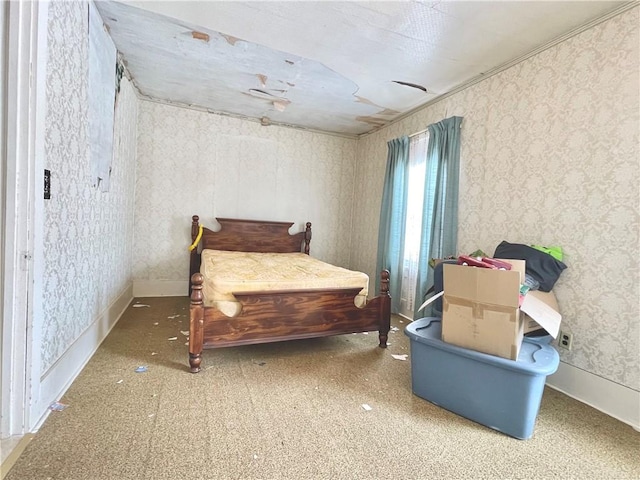 bedroom featuring baseboards and wallpapered walls