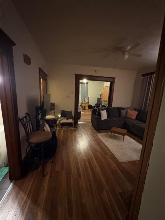 living room with a ceiling fan and wood finished floors