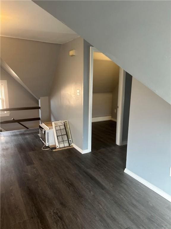 bonus room featuring lofted ceiling, baseboards, and wood finished floors