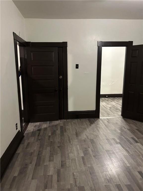 spare room with wood finished floors and baseboards