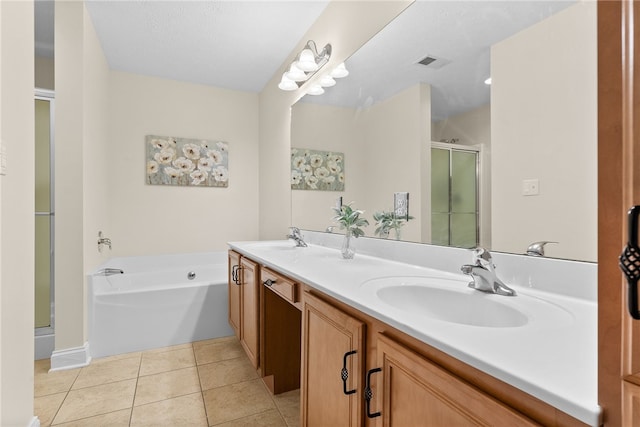 bathroom with a stall shower, tile patterned flooring, a sink, and visible vents