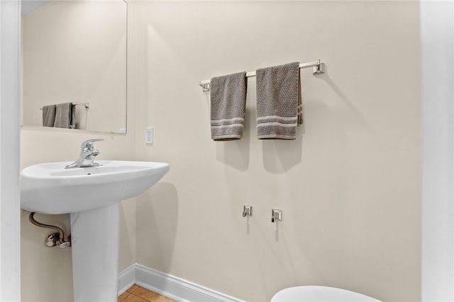 bathroom with tile patterned floors and baseboards