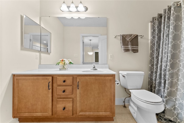 full bathroom with vanity, toilet, and baseboards