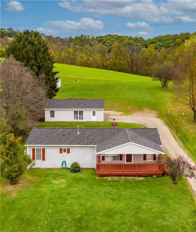 birds eye view of property with a view of trees