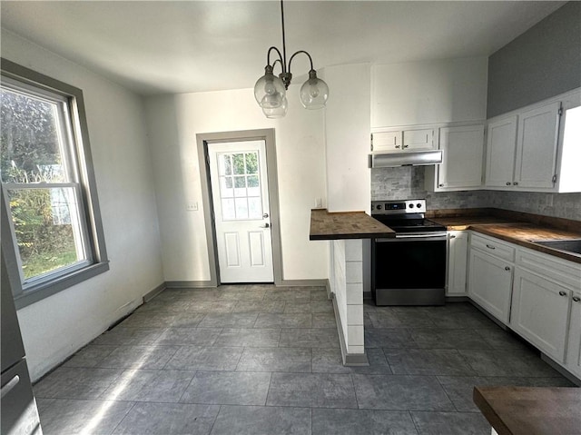 kitchen with stainless steel electric stove, backsplash, a healthy amount of sunlight, butcher block countertops, and under cabinet range hood