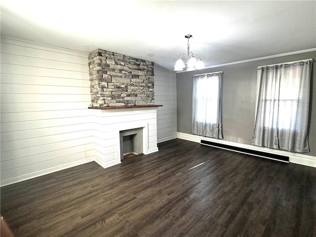 unfurnished living room with an inviting chandelier, a fireplace, ornamental molding, and wood finished floors