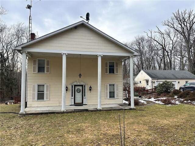 view of front of house with covered porch and a front yard