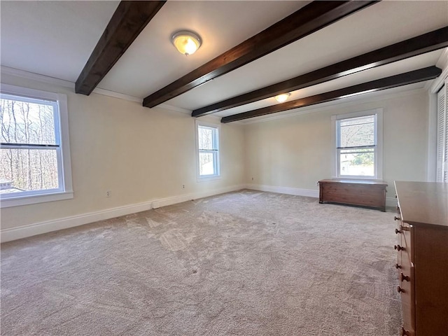 carpeted empty room featuring baseboards and beam ceiling