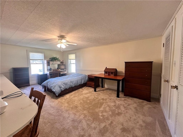 carpeted bedroom with a textured ceiling and ceiling fan