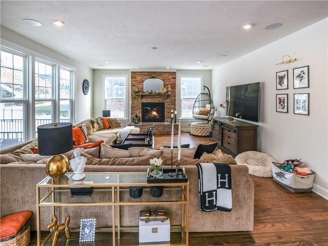 living area with baseboards, a fireplace, recessed lighting, and dark wood-style flooring