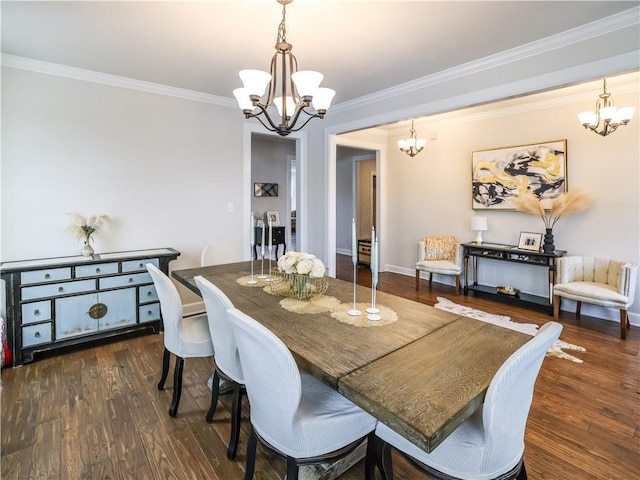 dining space featuring an inviting chandelier, crown molding, wood finished floors, and baseboards