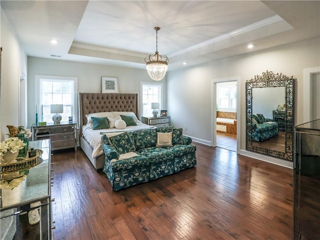 bedroom with ornamental molding, multiple windows, and a raised ceiling