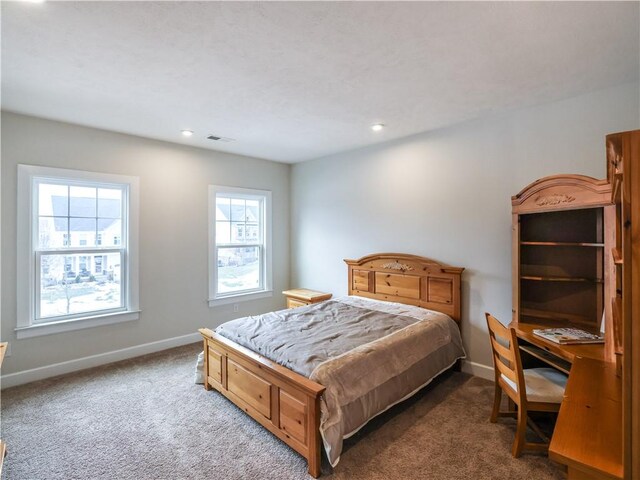 carpeted bedroom featuring baseboards, visible vents, and recessed lighting