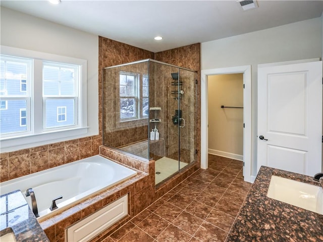 bathroom featuring a bath, visible vents, a sink, and a shower stall