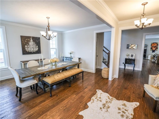 dining space featuring hardwood / wood-style flooring, a wealth of natural light, stairs, and an inviting chandelier