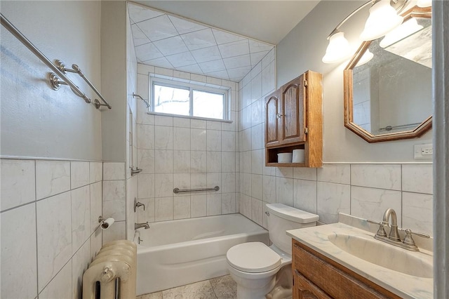 full bath with toilet, bathing tub / shower combination, vanity, tile walls, and radiator