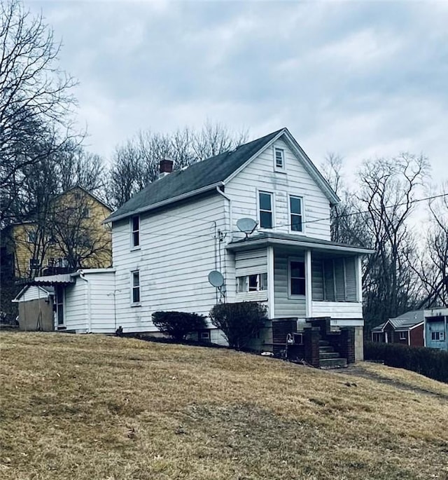 view of property exterior featuring a chimney and a yard