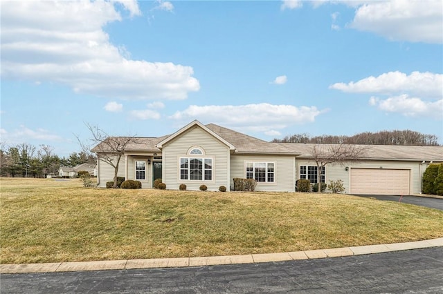 ranch-style house with a garage, driveway, and a front lawn