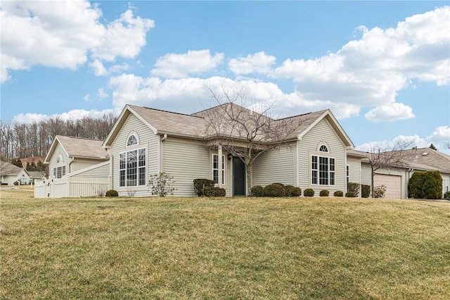 ranch-style house with a garage and a front lawn