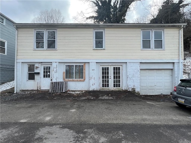 view of front of property featuring a garage and french doors