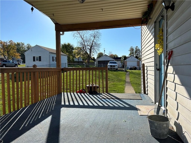 wooden deck featuring a residential view and a lawn