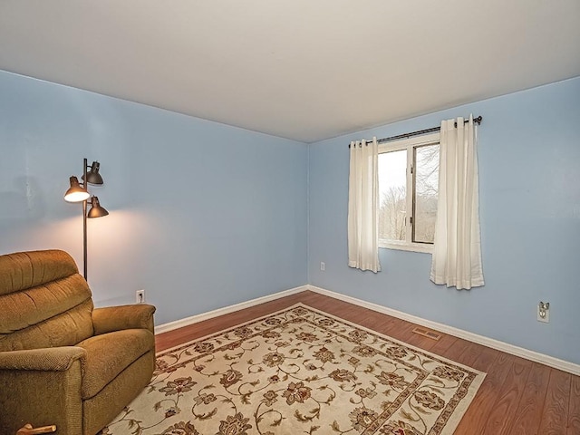 sitting room with wood finished floors and baseboards