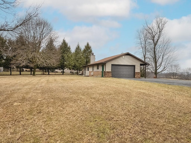 exterior space with aphalt driveway and a garage