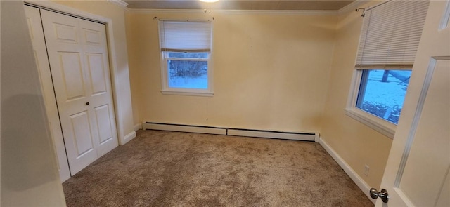 unfurnished bedroom featuring carpet floors, a baseboard radiator, multiple windows, and crown molding