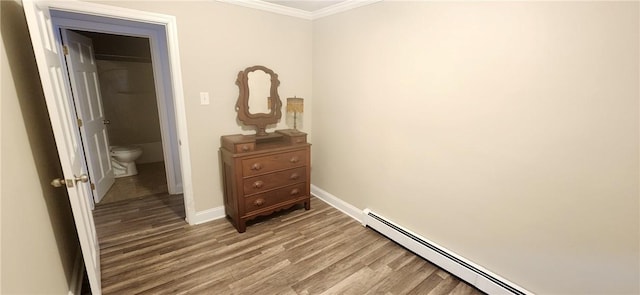 bedroom featuring baseboards, crown molding, light wood-style flooring, and baseboard heating