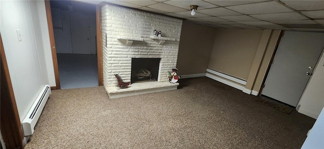 finished basement with a drop ceiling, a baseboard heating unit, carpet floors, a fireplace, and baseboard heating