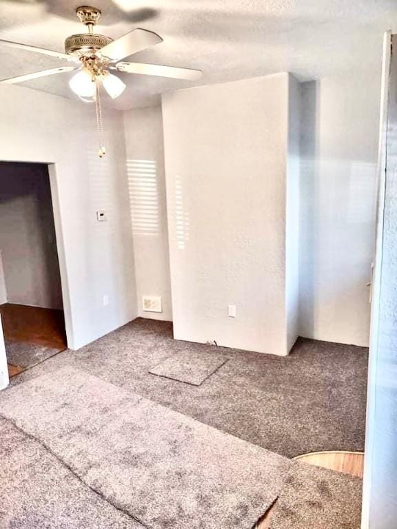 unfurnished bedroom with carpet flooring and ceiling fan