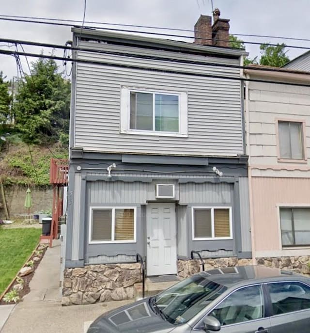 view of front of home featuring a chimney