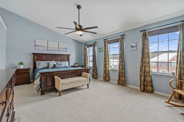 bedroom featuring light carpet, ceiling fan, baseboards, and lofted ceiling