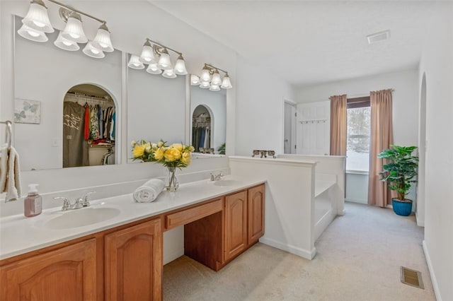 bathroom featuring double vanity, a sink, and visible vents