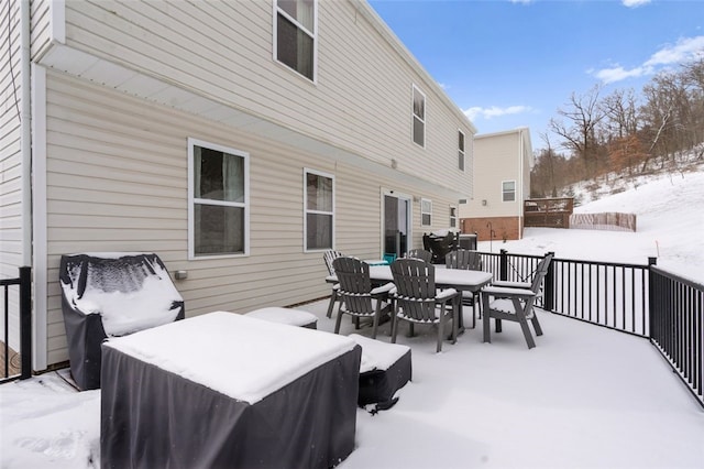 snow covered deck with outdoor dining area