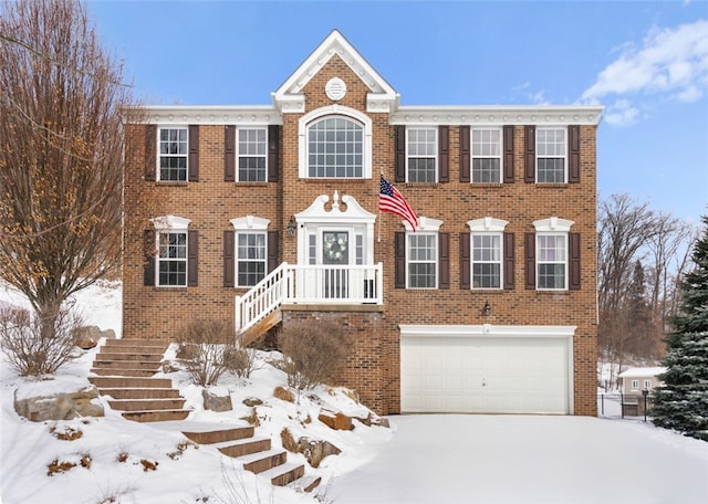 view of front facade with concrete driveway and brick siding