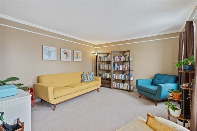 sitting room featuring carpet, crown molding, and baseboards