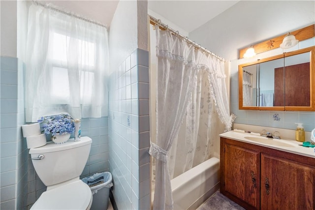 full bathroom with toilet, shower / tub combo with curtain, tile walls, and vanity