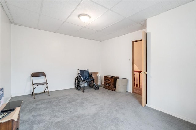 misc room featuring a paneled ceiling and carpet flooring