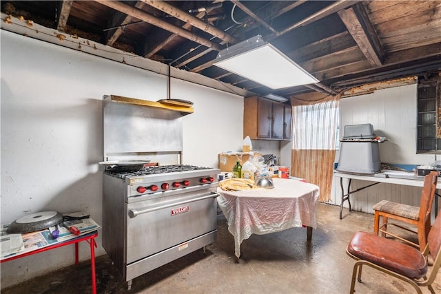 kitchen featuring stainless steel range and unfinished concrete floors