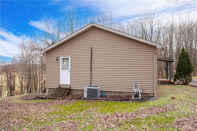 view of side of property with entry steps and central AC unit