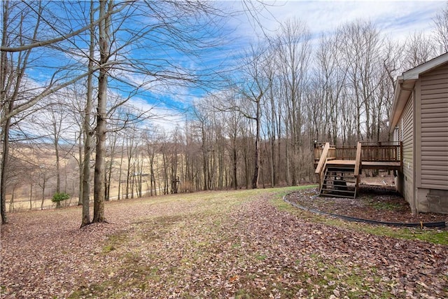 view of yard featuring a deck and stairway