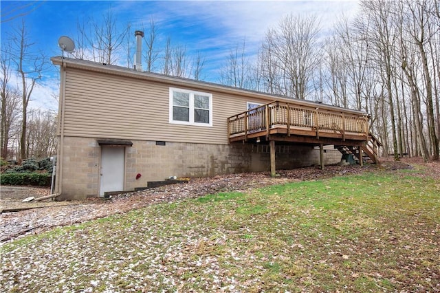 rear view of property with a yard, stairway, and a wooden deck