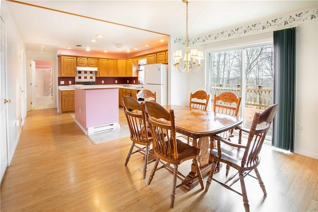 dining space featuring a chandelier, light wood finished floors, and recessed lighting